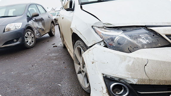 Two damaged cars on road after an accident - The Law Office Of Fred A Medina PLLC