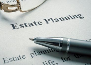 Pen and paper with 'Estate Planning' written on it - The Law Office Of Fred A Medina PLLC